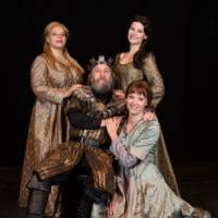 Actors in costume portraying King Lear and his three daughters